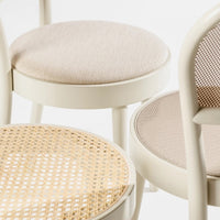 Beige and cream upholstered chair seats with woven rattan patterns and smooth finishes. Perfect for modern decor.