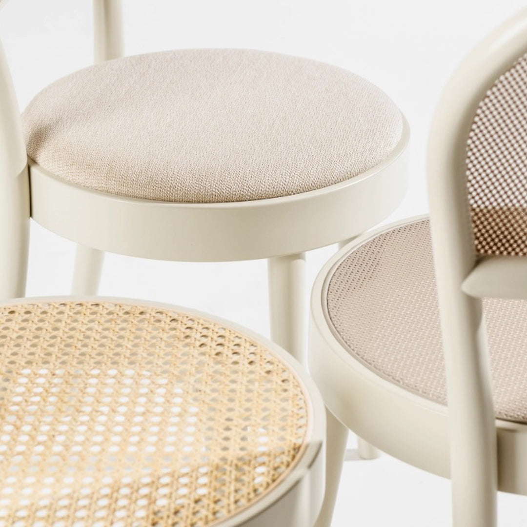 "Beige and natural woven patterns on modern chair seats with soft, muted tones for a minimalist look."