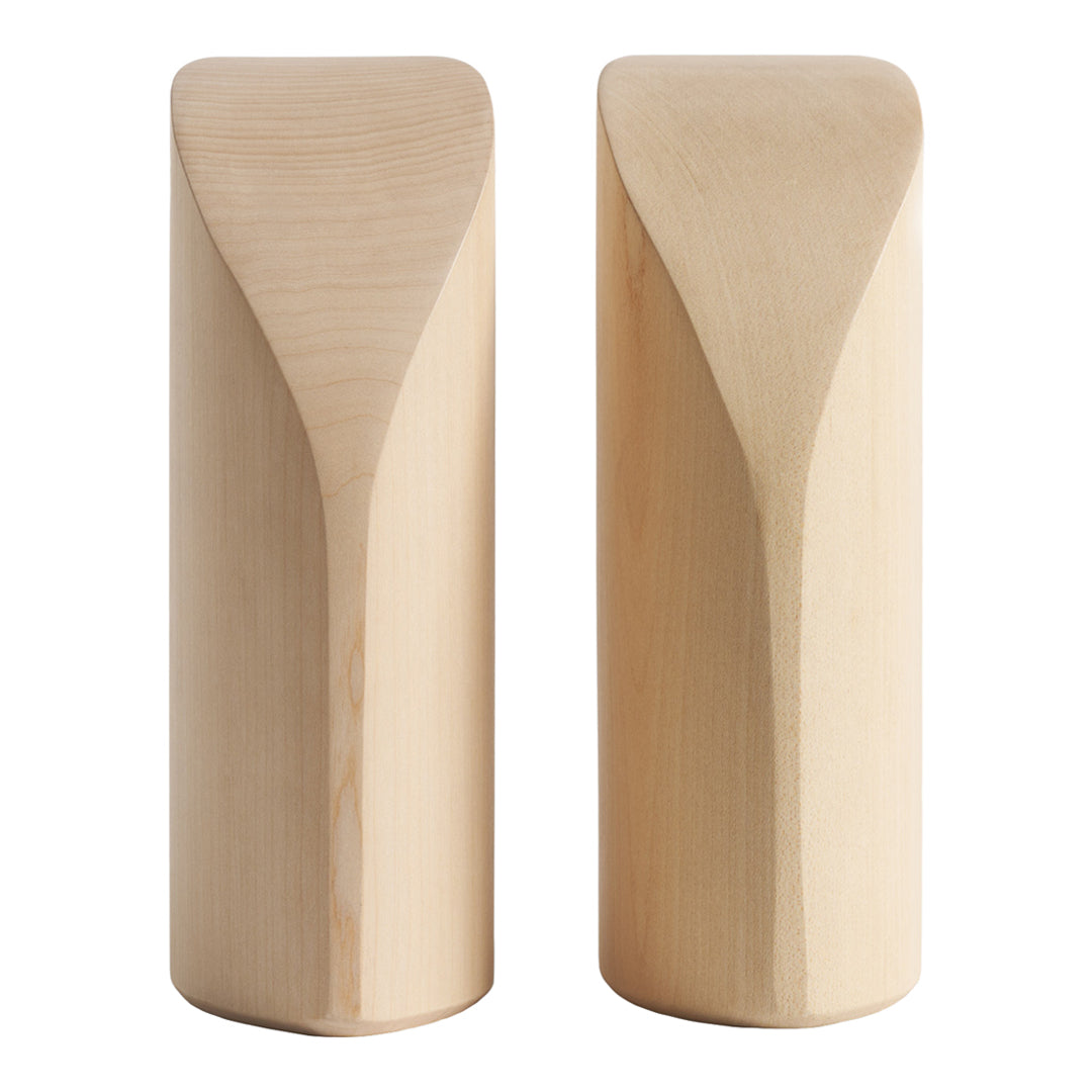 Natural light wood sculptural pieces with smooth, curved patterns and a minimalist design.
