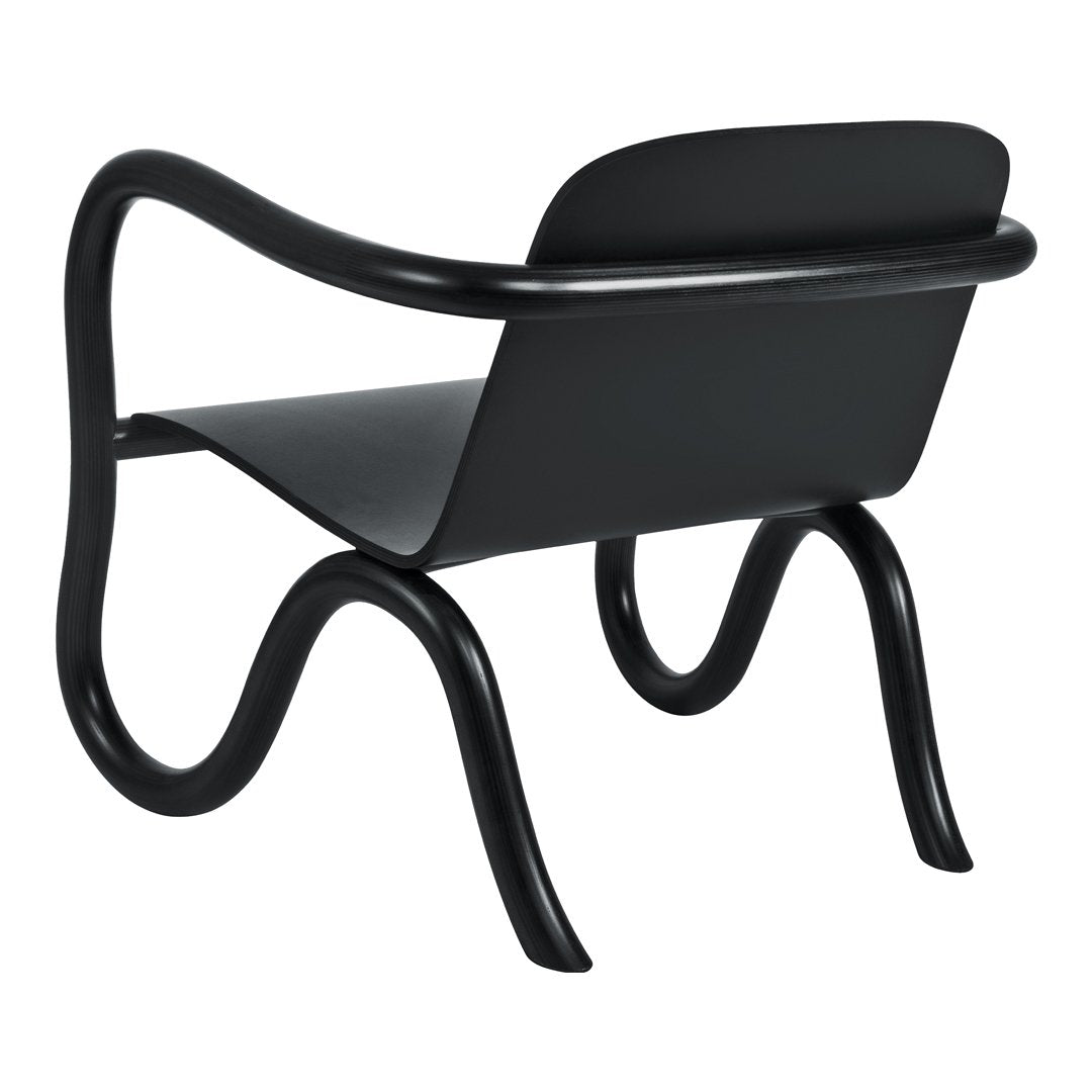 Sleek black chair with smooth curves and a minimalist design, featuring solid black wood and matte finishes.