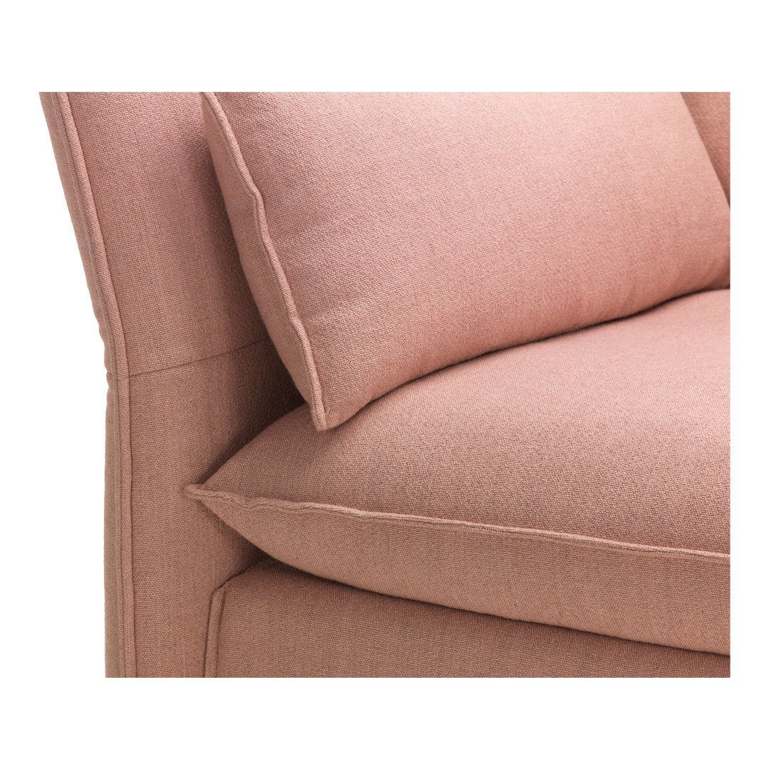 Close-up of soft pink upholstery with subtle texture and coordinating plush cushions, ideal for modern home decor.