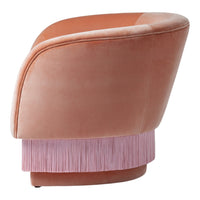 Velvet chair in soft peach with a pink fringed base, stylish and vibrant for modern decor.