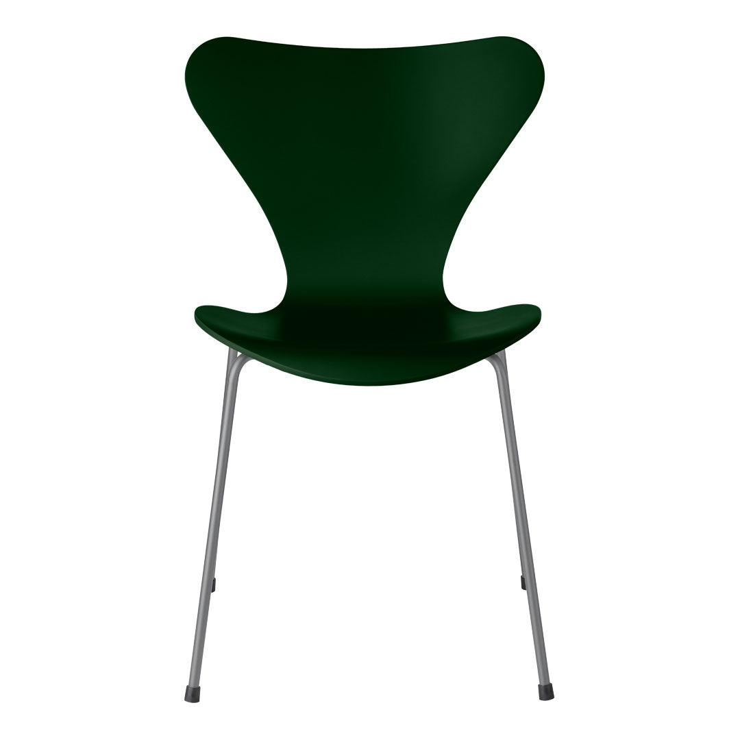 Green modern chair with a sleek, curvy design and silver metal legs. Ideal for contemporary decor.
