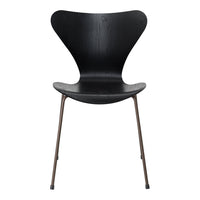 Black wooden chair with a stylish butterfly design and sleek metal legs. Elegant and modern home decor piece.