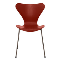 Red sculptural chair with a smooth, glossy finish and minimalist design, perfect for modern decor.