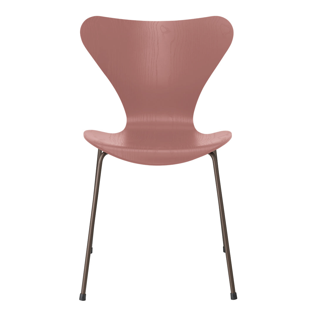 Pink curved chair with a sleek design and metallic legs. Modern and stylish for any décor.