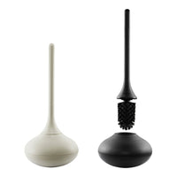 Two modern toilet brush holders in matte white and black, featuring minimalist design and smooth surfaces.