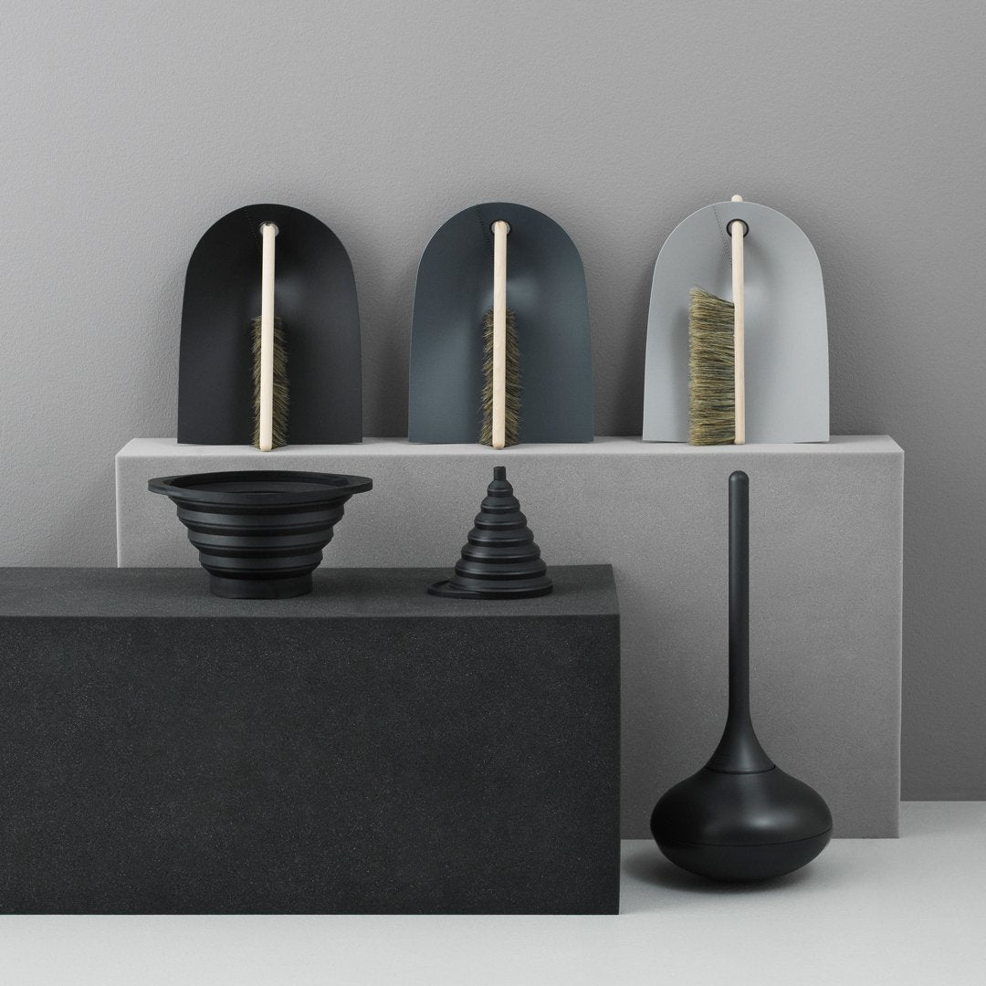 "Elegant black and gray vases with unique shapes and textures, set against a minimalist backdrop."