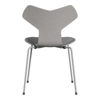 Gray minimalist chair with a unique three-part backrest and sleek silver legs. Modern design for any decor.
