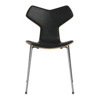Black chair with a sleek, modern design, featuring a unique shape and contrasting wooden edge. Ideal for contemporary decor.