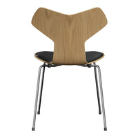 "Stylish wooden chair with a natural finish, black seat, and sleek chrome legs, featuring an elegant, modern design."