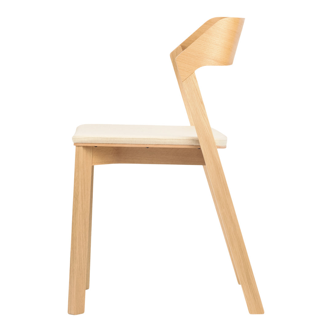 Modern wooden chair in natural light wood finish with a soft cream seat cushion, minimalist design.