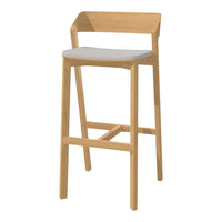 Light oak bar stool with a minimalist design and a soft gray seat cushion. Smooth finish and natural wood grain.