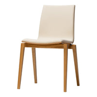 "Minimalist cream chair with smooth upholstery and natural wood legs, perfect for modern decor."