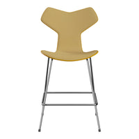 Yellow bar stool with a unique Y-shaped backrest and sleek silver metal legs, ideal for modern decor.