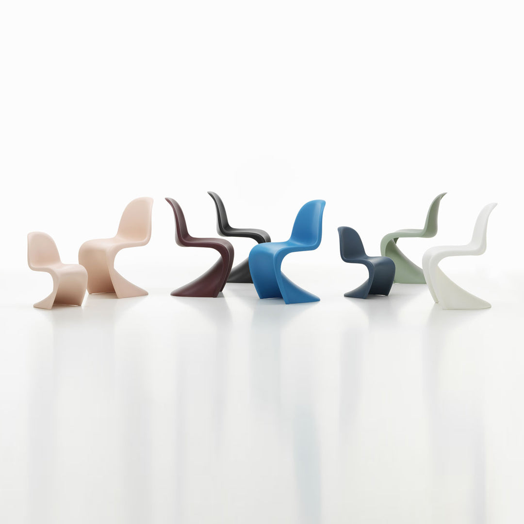 Colorful modern chairs showcase soft pink, deep red, cool blue, dark green, and crisp white in sleek, curved designs.