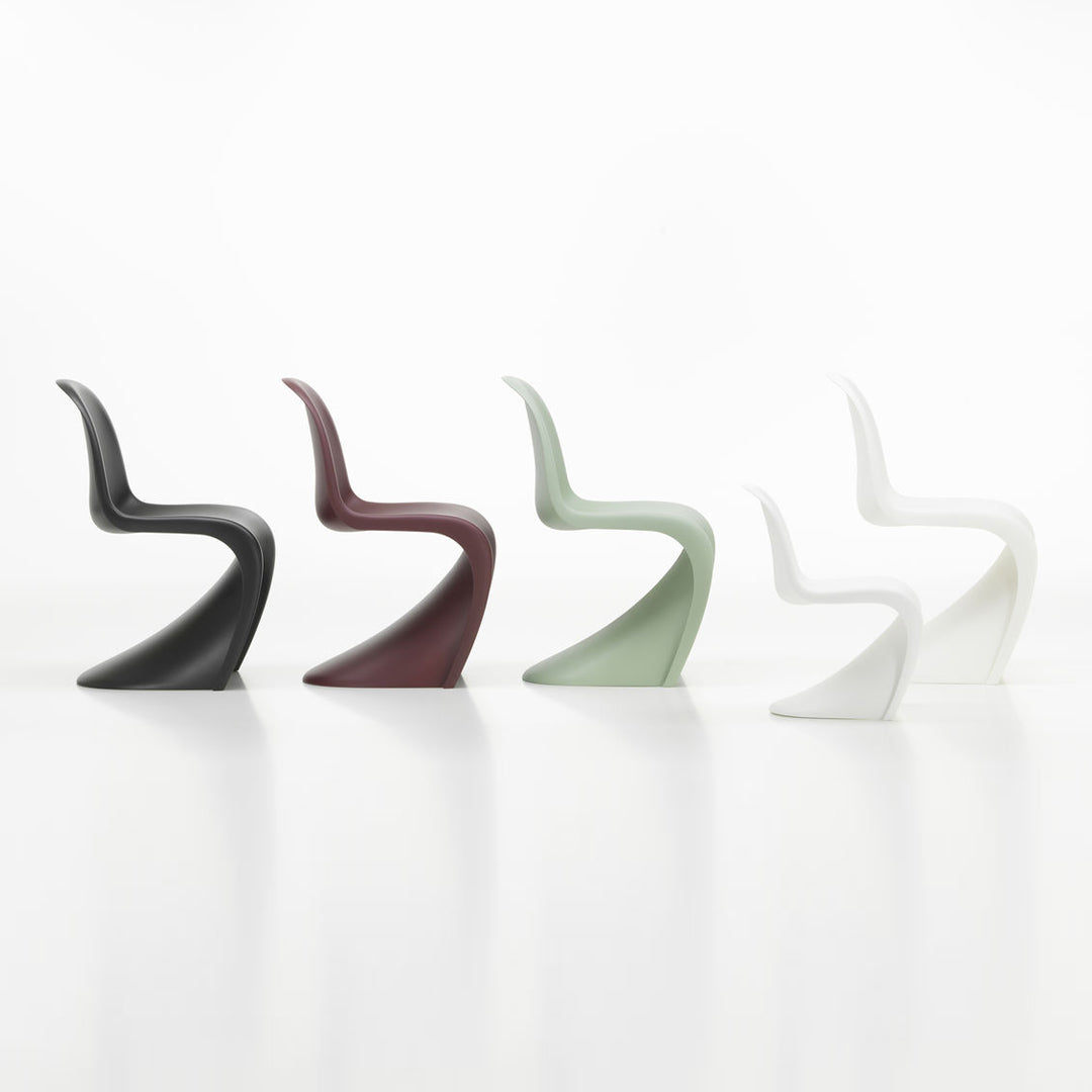 Four sleek chairs in black, burgundy, sage green, and white, showcasing modern minimalist design and smooth curves.
