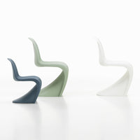 Three stylish chairs in dark blue, soft green, and crisp white, showcasing sleek curves and modern design.