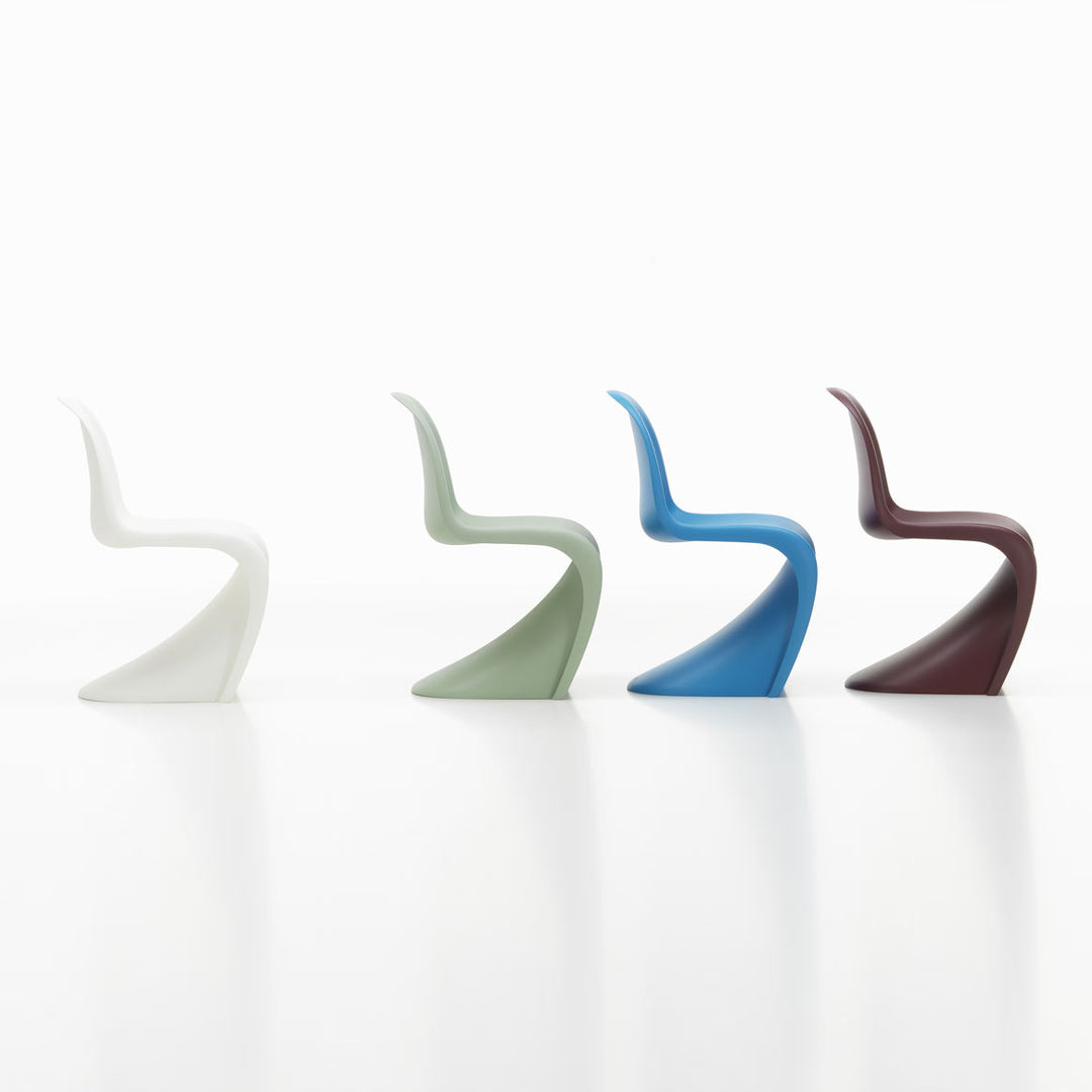 Modern chair set featuring white, green, blue, and brown colors with unique, stylish curves and smooth finishes.