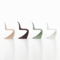 Four stylish chairs in blush pink, deep burgundy, muted green, and crisp white, showcasing sleek, modern designs.