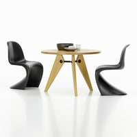 Modern round wooden dining table with natural finish, paired with sleek black curved chairs, minimalist design.