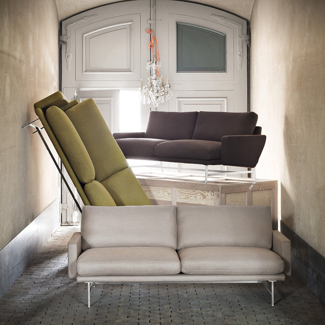 Stylish sofas in green, brown, and light gray hues against a vintage backdrop. Modern design meets classic elegance.