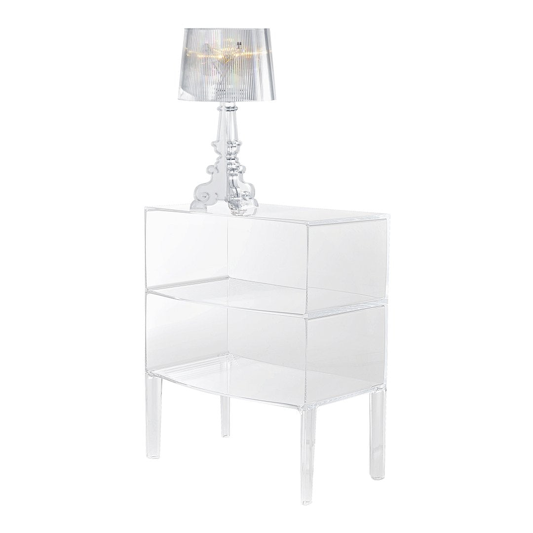 Clear acrylic nightstand with glossy finish and modern design, complemented by a silver striped lamp shade.