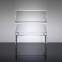 Clear acrylic shelving unit with sleek black legs, showcasing a minimalist design on a gray background.