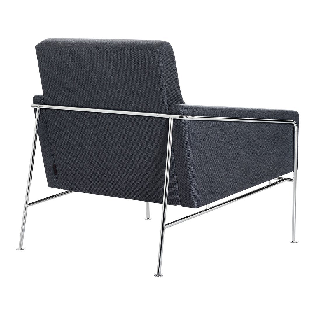 Dark gray chair with sleek chrome legs, featuring a minimalist design and smooth fabric texture.