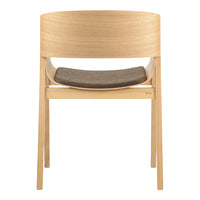 Light wood chair with a smooth, curved back and a dark gray fabric seat. Minimalist design, neutral color palette.