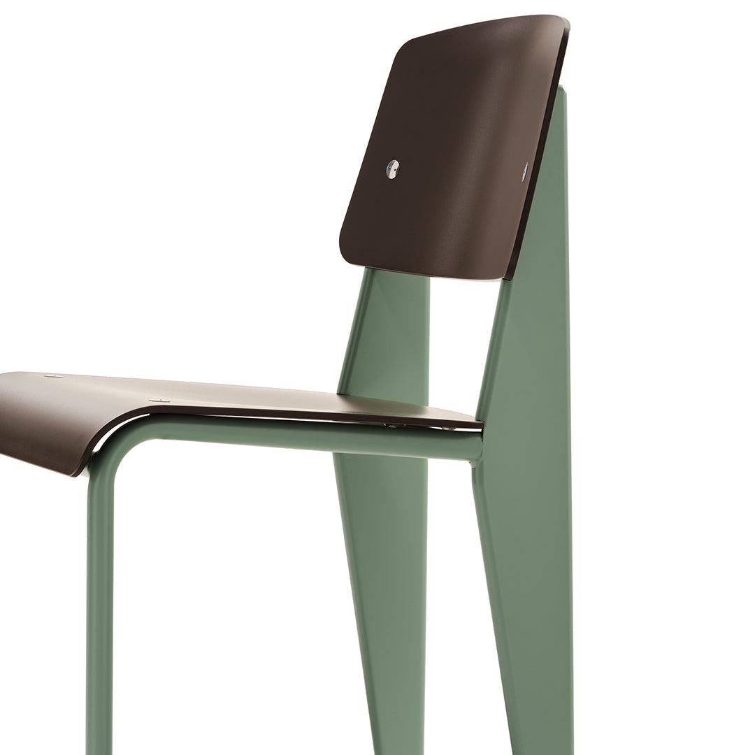 Brown wooden seat with a green metal frame in a minimalist design. Perfect blend of modern colors and sleek patterns.