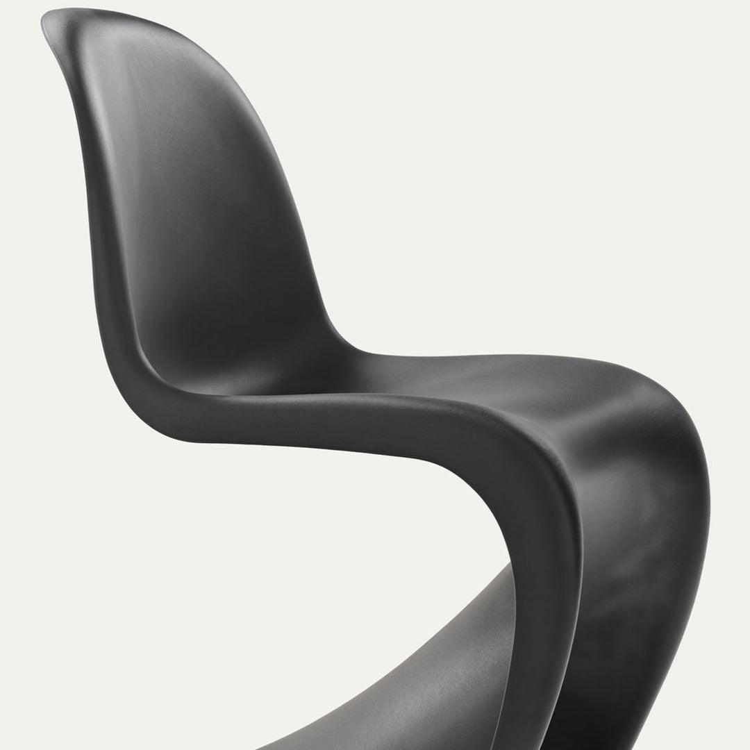"Modern black chair featuring smooth, sleek curves and a minimalist design, perfect for contemporary decor."