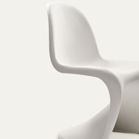Sleek white chair with smooth, modern curves against a soft, neutral background. Minimalist design, perfect for contemporary decor.