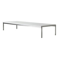 Sleek white tabletop with polished silver legs, perfect for modern spaces. Simple and elegant design.