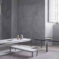 Modern gray and white coffee tables with sleek metal legs, featuring minimalist designs and subtle textures.