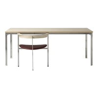 Modern desk with a light wood finish and chrome legs, paired with a sleek chair featuring a red cushion.
