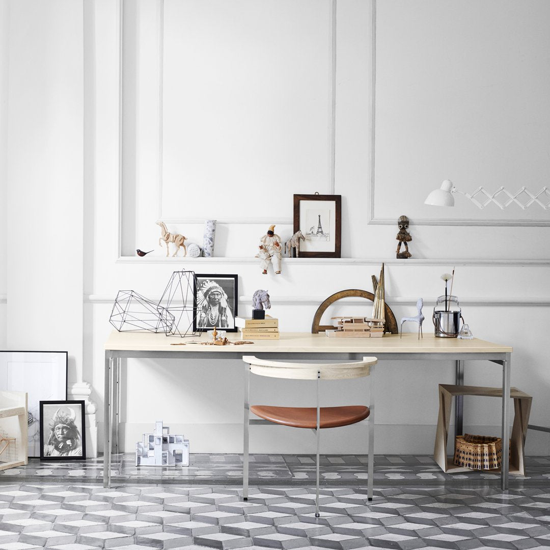 Scandi-style workspace featuring a monochrome geometric floor pattern and neutral decor accents with wooden elements.