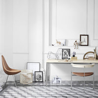 Scandi-style workspace featuring a monochrome geometric floor pattern and neutral decor accents with wooden elements.