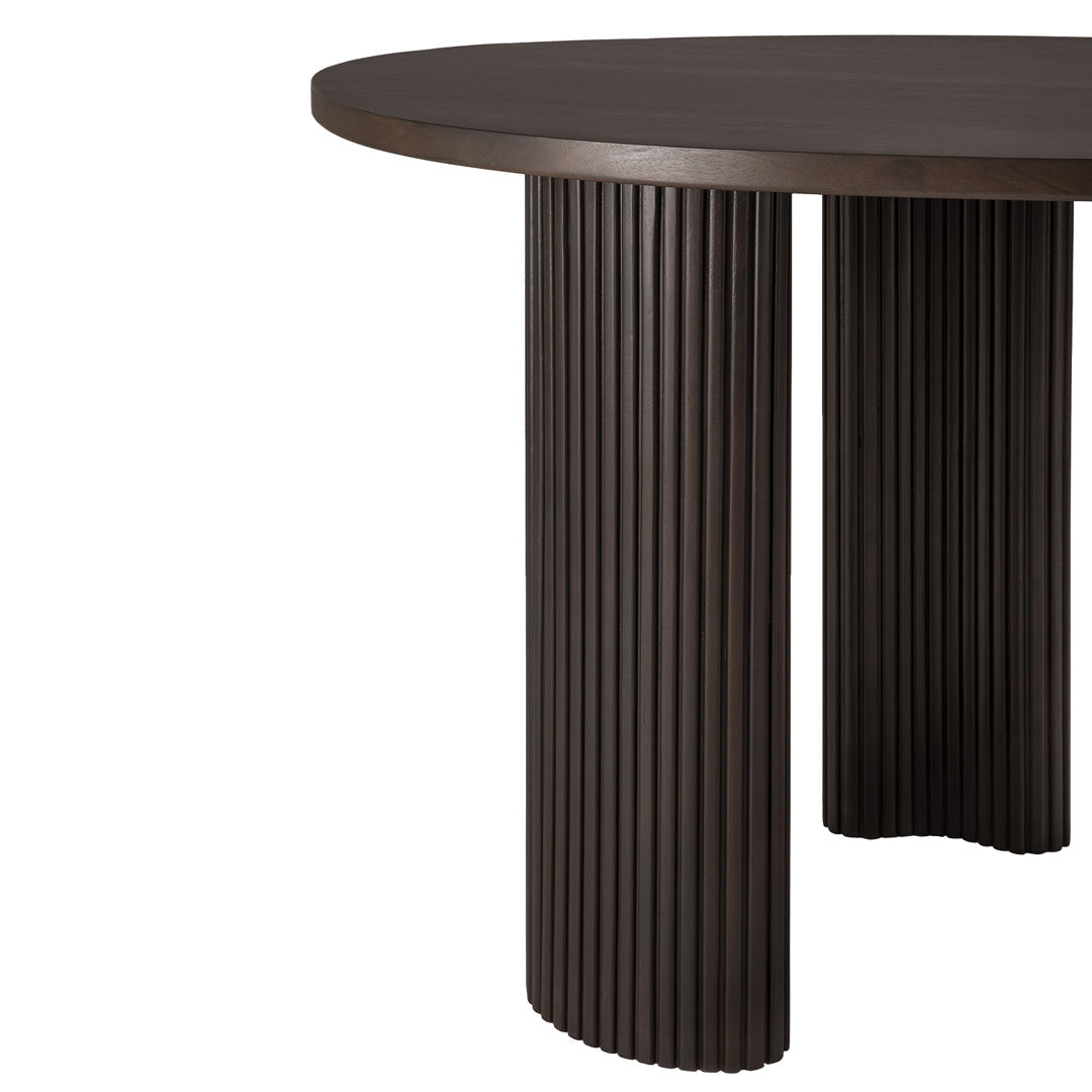  sleek round table in dark wood with ribbed column legs, showcasing a modern and elegant design.