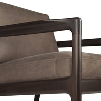 Brown leather armchair with dark wood frame, featuring sleek lines and a minimalist design. Perfect for modern decor.