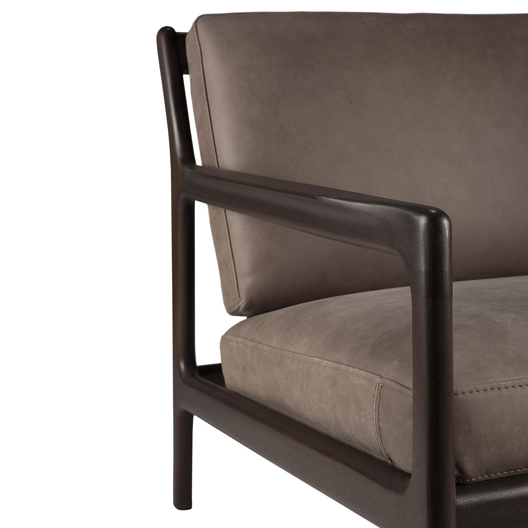 Modern brown armchair with a sleek dark wooden frame and a soft, textured suede seat.