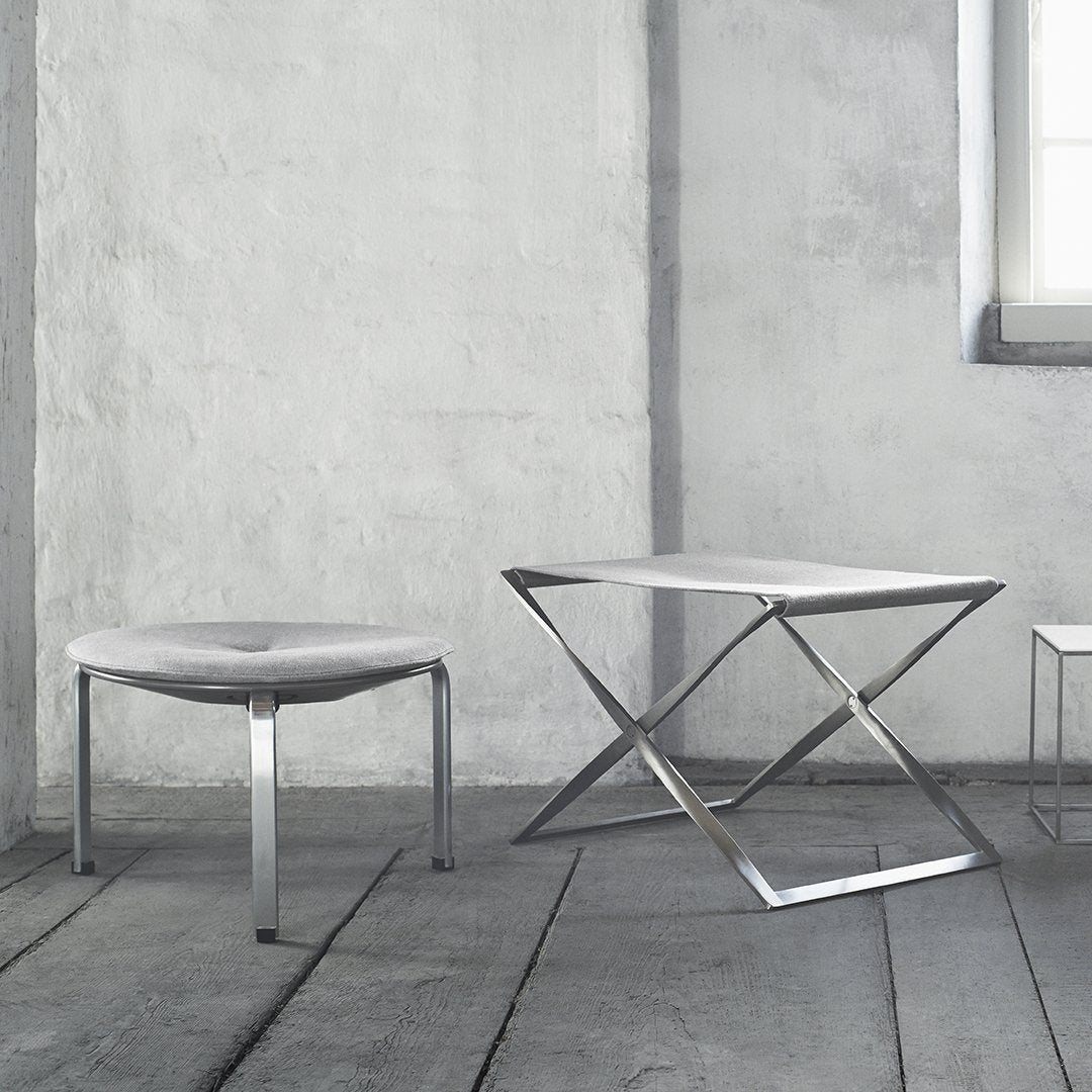 Modern gray furniture set featuring sleek metal accents and minimalist design on a textured floor.