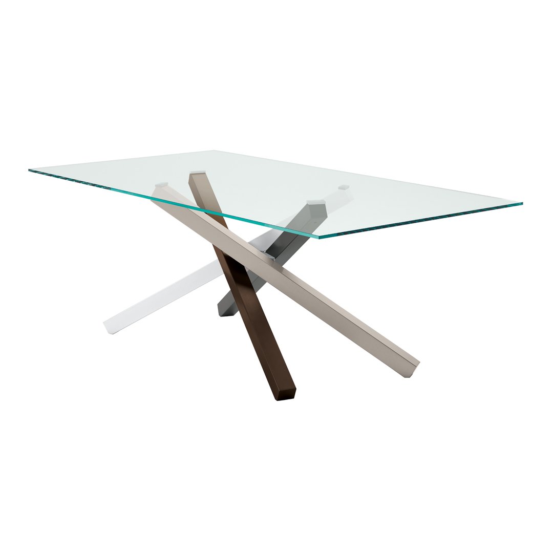 Modern glass dining table with crossed metal legs in silver, black, and a natural wood finish. Minimalist design.