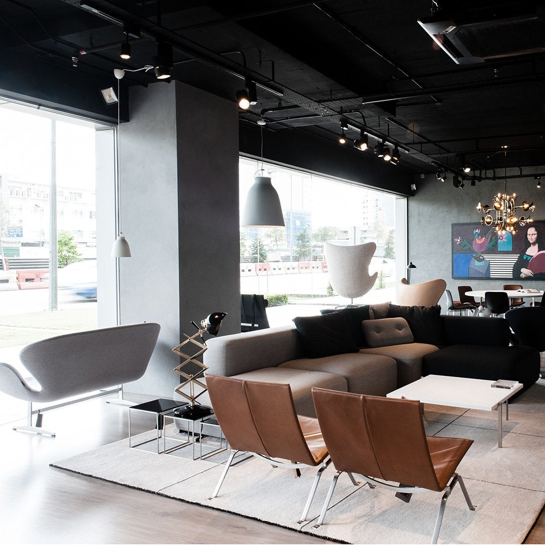 Modern living room with a mix of gray and brown furniture, sleek lines, and minimalist decor.