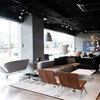 Modern living room with a mix of gray and brown furniture, sleek lines, and minimalist decor.