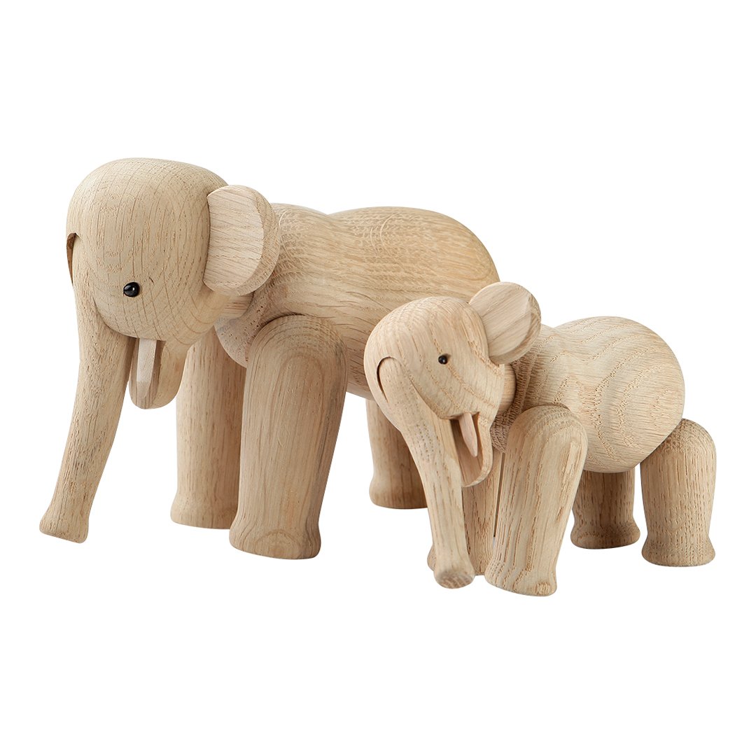 Natural wooden elephant figurines, unpainted with light wood grain and smooth curves, showcasing a minimalist design.