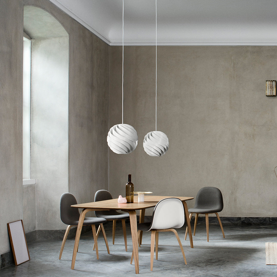 "Elegant gray walls, minimalist wooden table, and modern light fixtures with subtle white and gray patterns."