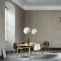 "Elegant gray walls, minimalist wooden table, and modern light fixtures with subtle white and gray patterns."