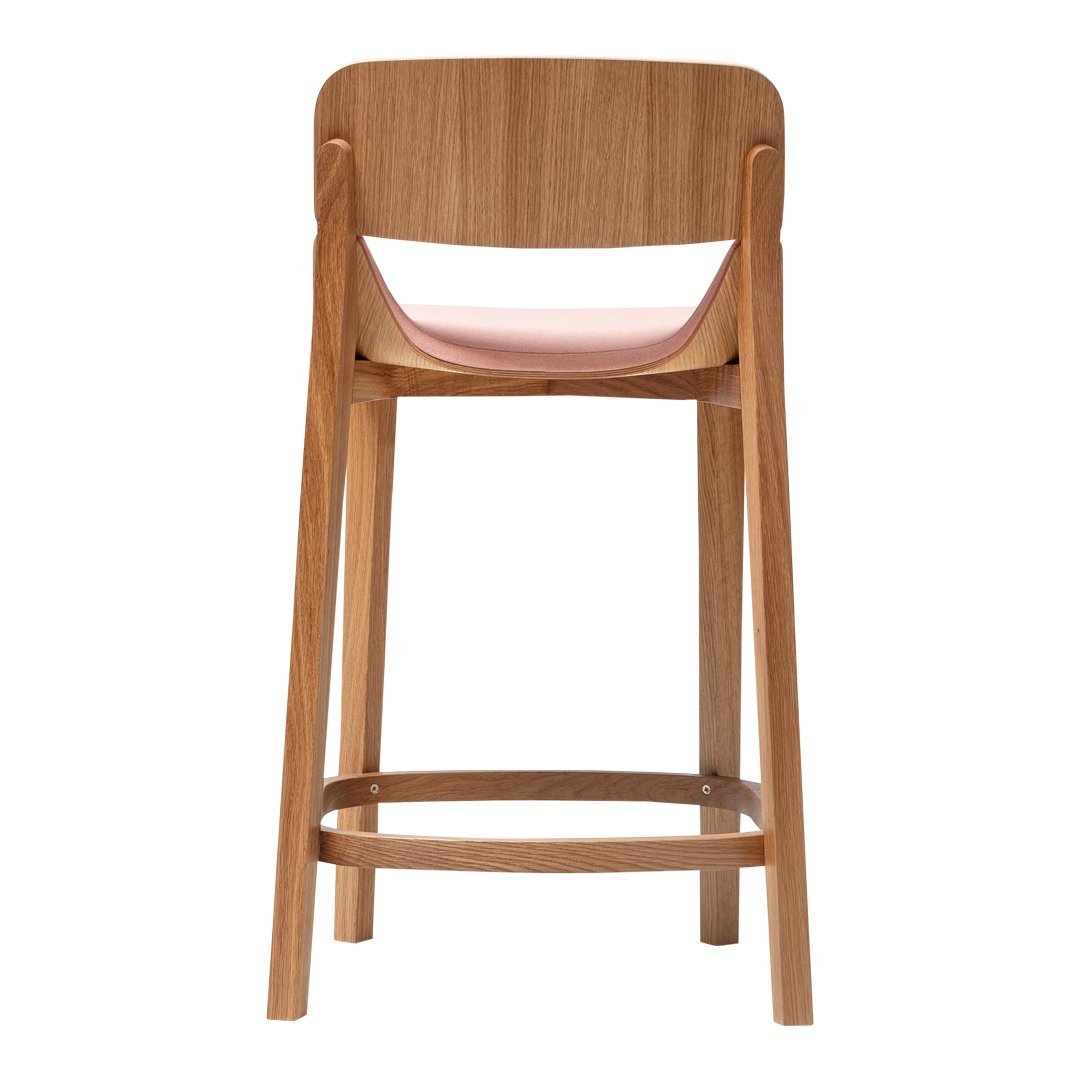 Wooden barstool with a light pink seat and natural wood finish, featuring a smooth, minimalist design.