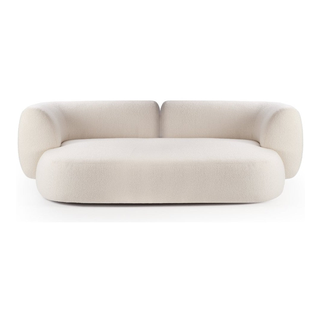Soft beige sofa with rounded edges and plush, smooth fabric. Contemporary design, minimal patterns, perfect for modern decor.